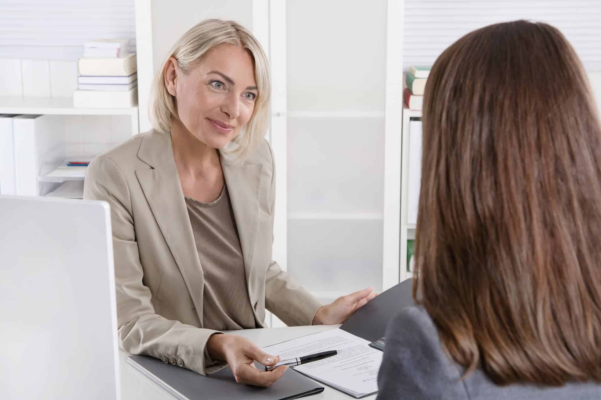 Female executive interviewing a young woman.